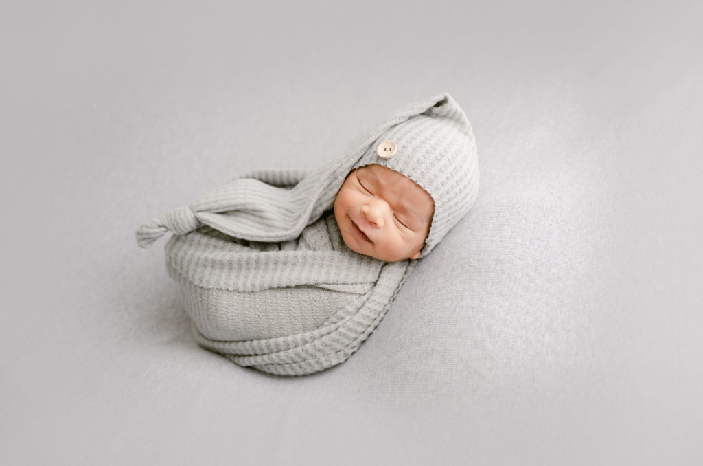 Posed Newborn Photograph on a Beanbag in Greys
| an education on what to ask your newborn photographer so ensure that you get a good one that will handle your infant safely